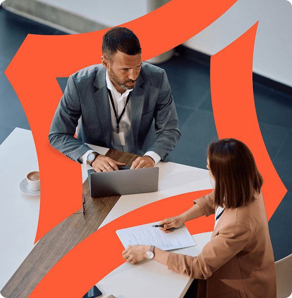 Business professionals collaborating at a modern office table with digital devices.